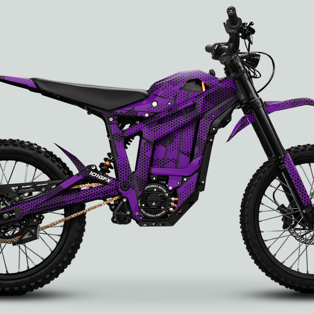 Talaria Sting MX5 PRO Graphics Kit HEXOCAM PURPLE Decals on electric dirt bike with knobby tires, long-travel suspension, and disc brakes for enhanced style and durability.