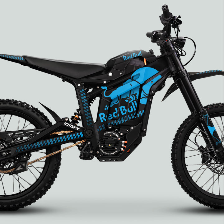 Side-profile of Talaria Sting MX5 PRO Graphics Kit RBULL MONO Black Cyan Decals on an electric dirt bike, showcasing Red Bull branding and off-road features.