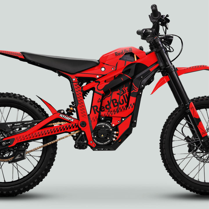 Side view of Talaria Sting MX5 PRO Graphics Kit RBULL MONO Red Black Decals on an electric off-road motorcycle with high-efficiency motor housing.