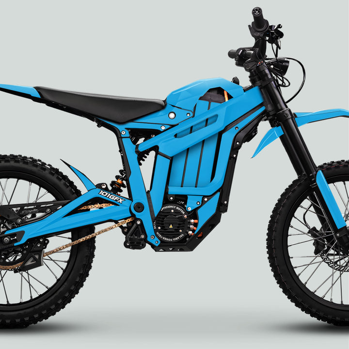 Side-view of a blue electric dirt-bike with Talaria Sting MX5 PRO Graphics Kit, showcasing a robust frame, electric motor, suspension, and off-road tires.