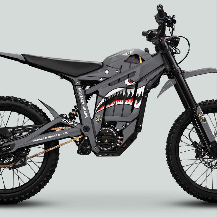 Side view of Talaria Sting MX5 PRO Graphics Kit MILITARY SHARK Grey Decals on an electric dirt-bike, featuring shark-tooth livery and knobby tires.