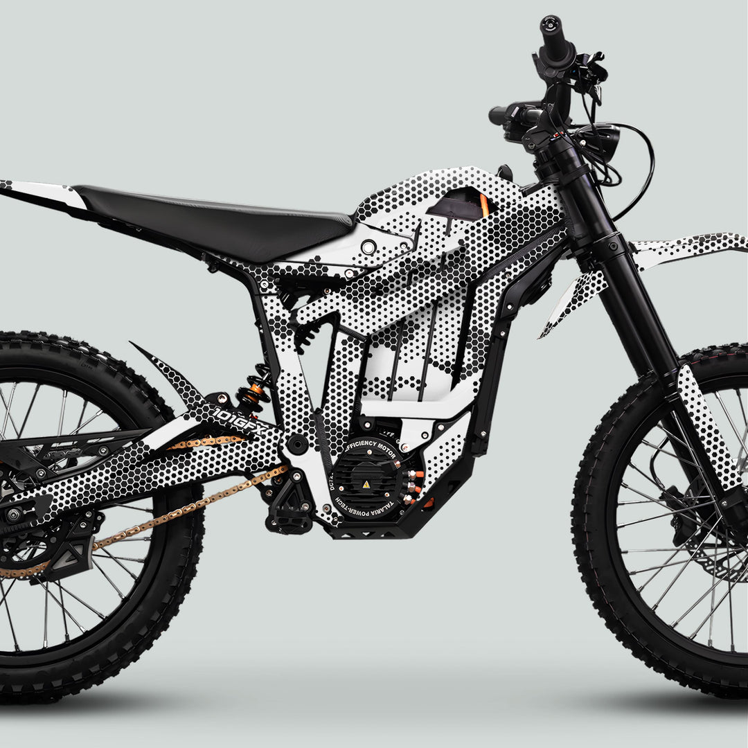 Talaria Sting MX5 PRO Graphics Kit HEXOCAM WHITE Decals on off-road electric motorcycle, showcasing high-clearance frame, knobby tires, and full suspension for enhanced style and performance.