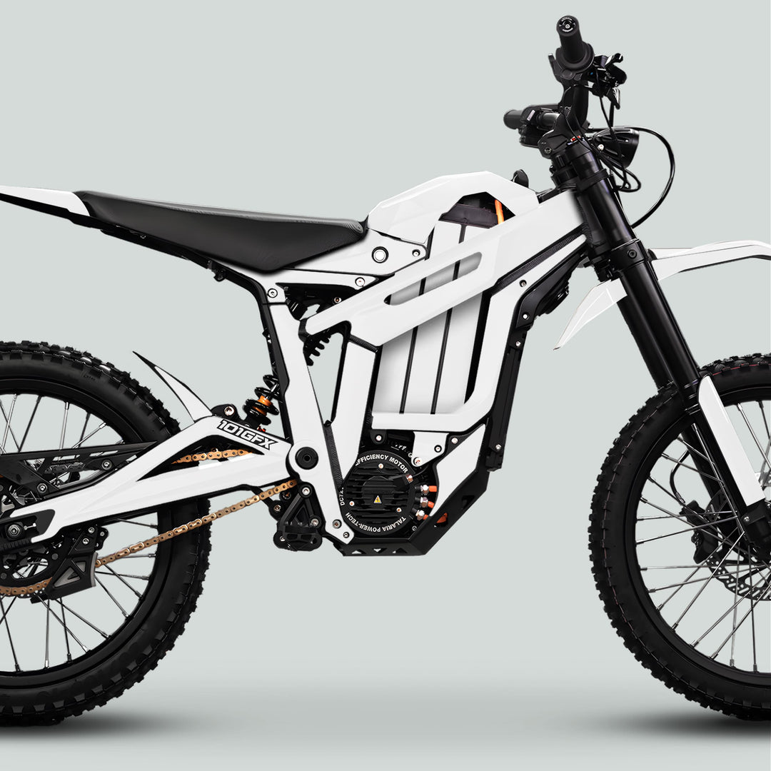 Side-profile of a white electric off-road motorcycle showcasing Talaria Sting MX5 PRO Graphics Kit SOLID COLOR White Decals, featuring knobbly tires and high-efficiency motor.