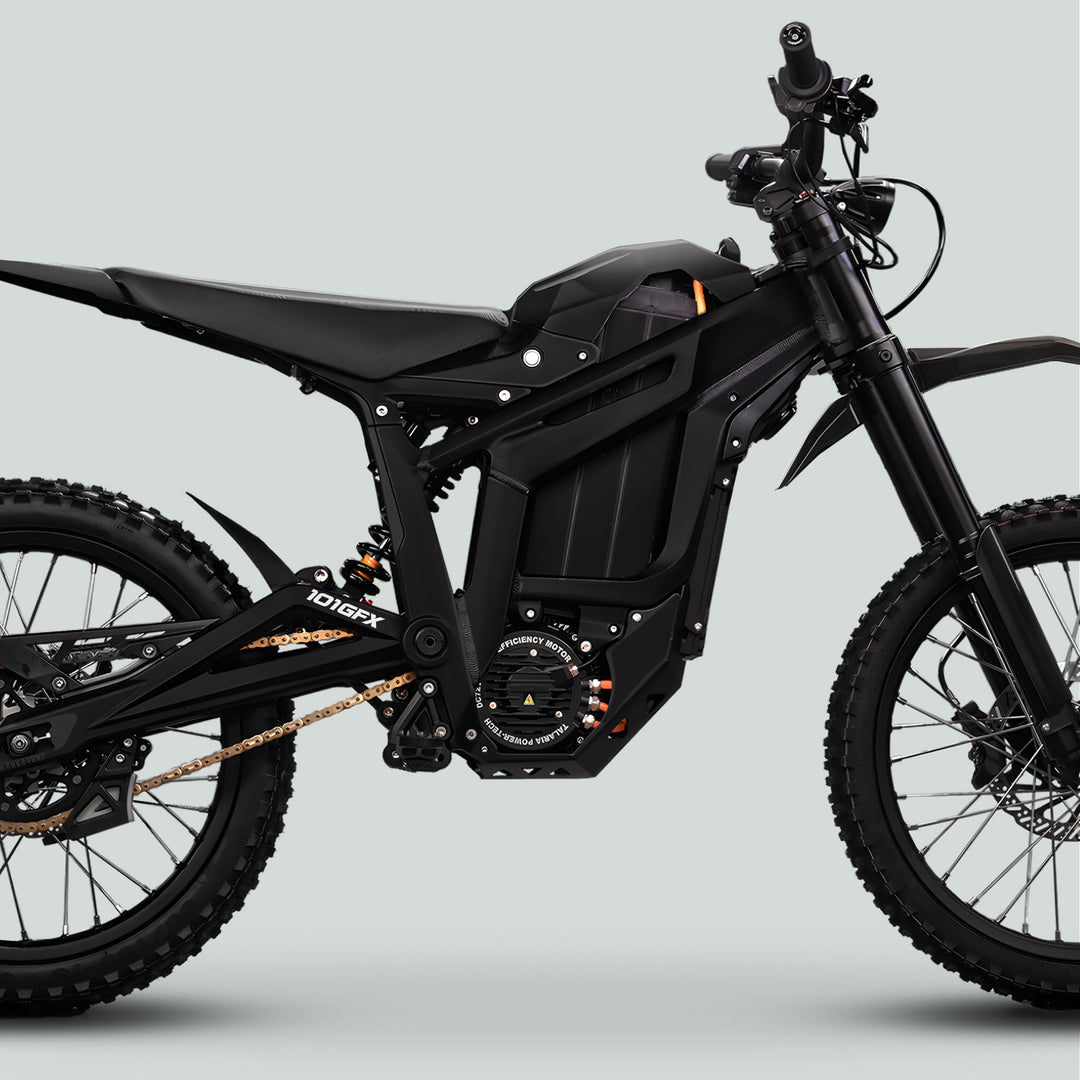 Side profile of a Talaria Sting MX5 PRO with SOLID COLOR BLACK Decals, featuring a large battery, knobby tires, and aluminum swingarm for off-road riding.