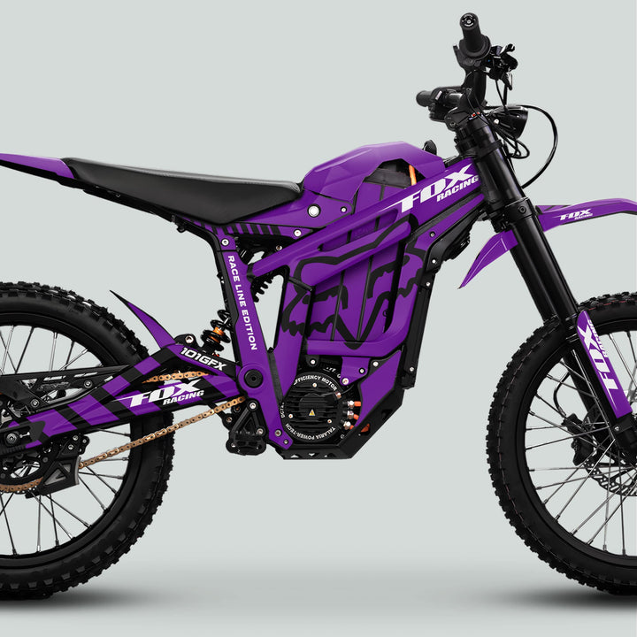Side view of the Talaria Sting MX5 PRO Graphics Kit FOX RACELINE, showcasing purple-black decals, tubular frame, and Fox-branded plastics on an e-dirtbike.