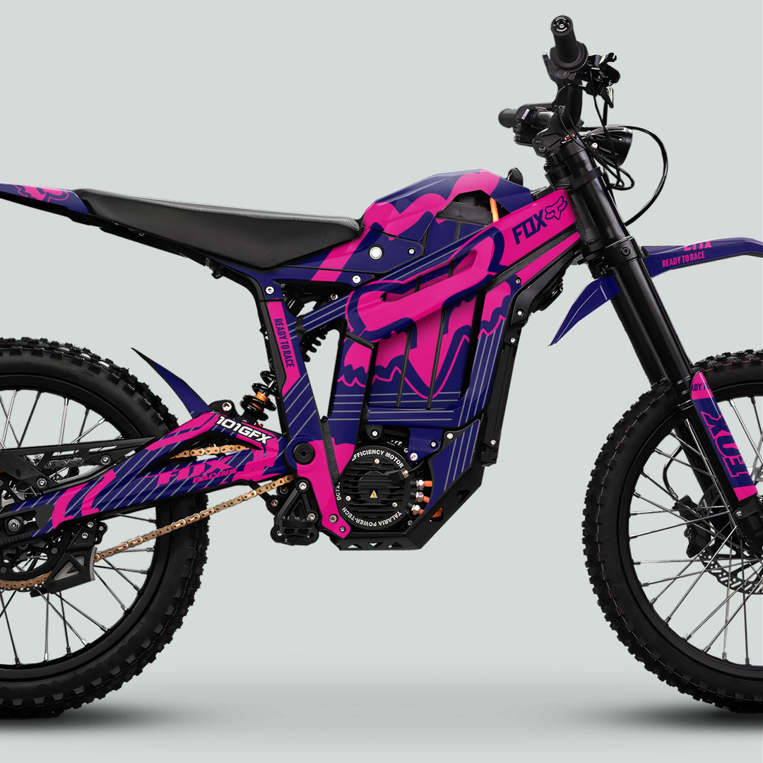 Side-view of a Talaria Sting MX5 PRO with FOX STRIPES Navy Magenta Decals, featuring full suspension, knobby tires, and vibrant graphics enhancing its electric design.