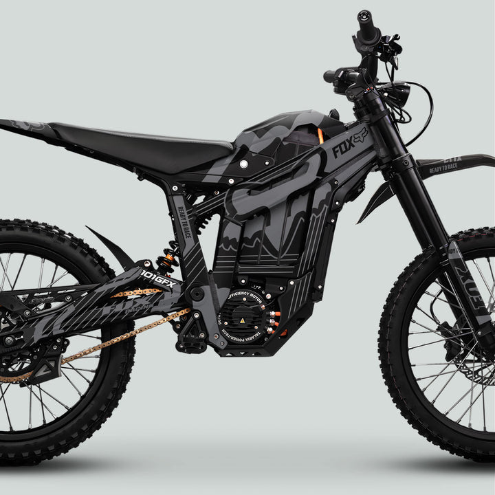 Side-profile of a Talaria Sting MX5 PRO with FOX STRIPES Black Grey Decals, showcasing full-suspension, knobby tires, and FOX graphics on the frame.
