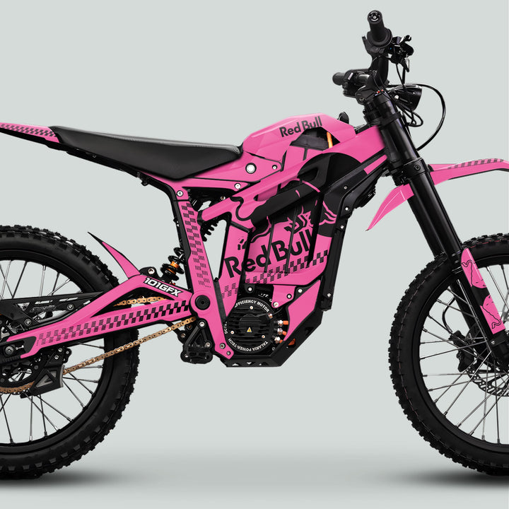 Pink electric motorcycle adorned with Talaria Sting MX5 PRO Graphics Kit, featuring Red Bull logos, knobby tires, and suspension, showcasing the RBULL MONO Pink Black Decals.
