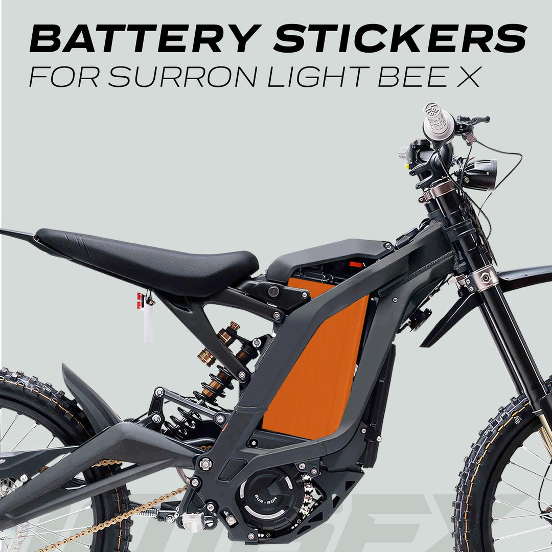 Side view of a Sur-Ron Light Bee X with SOLID Orange battery stickers, enhancing the bike's appearance and providing durable protection.