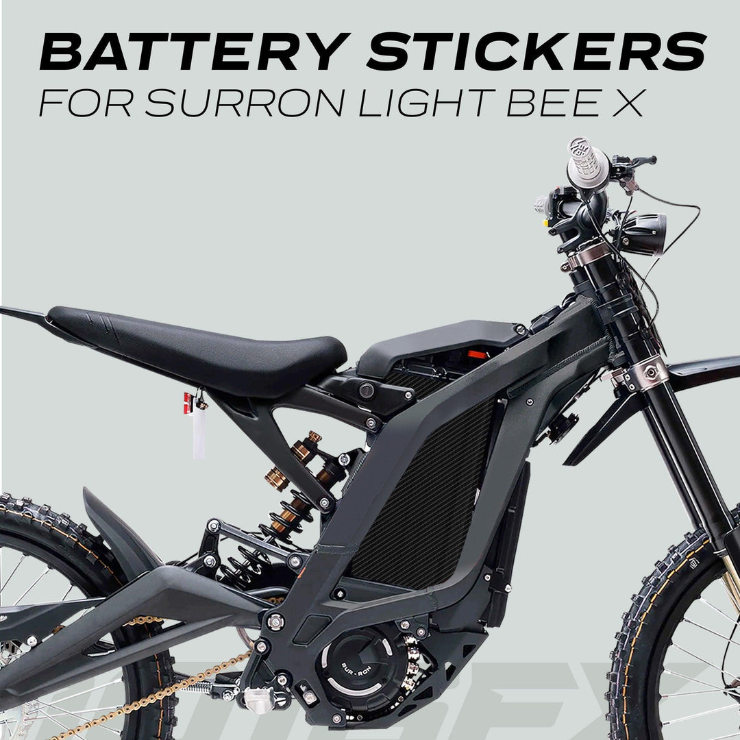 Surron Light Bee X Battery Stickers CARBON shown on bike's side profile, highlighting frame, suspension, battery compartment, with modern, durable design against light gray background.
