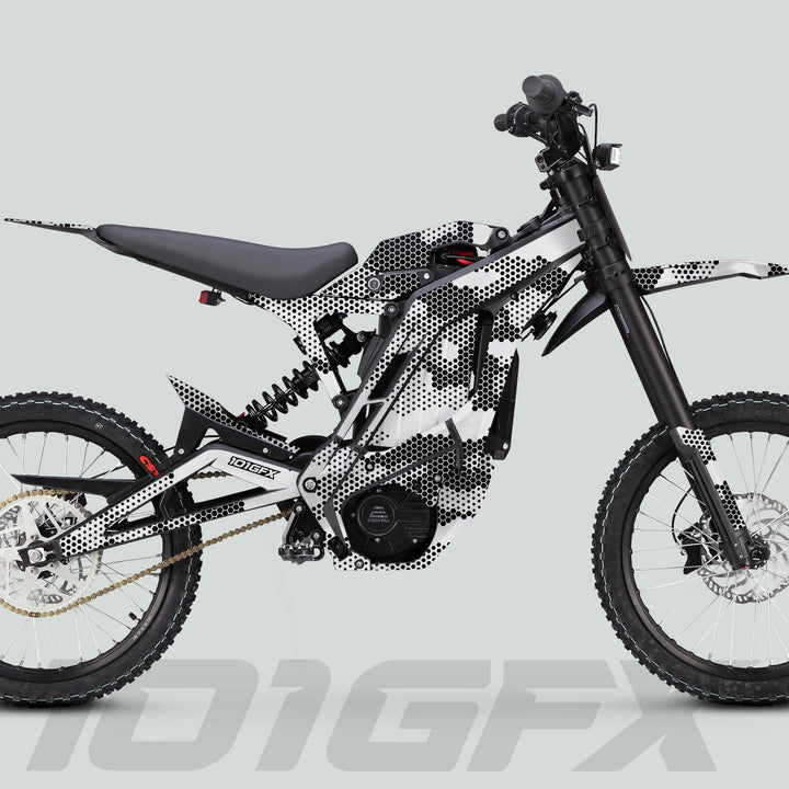 Side-profile of an electric dirt-bike featuring the E Ride Pro SS Graphics Kit HEXOCAM WHITE, showcasing a minimalist frame cover with black-and-white dot-pattern graphics.