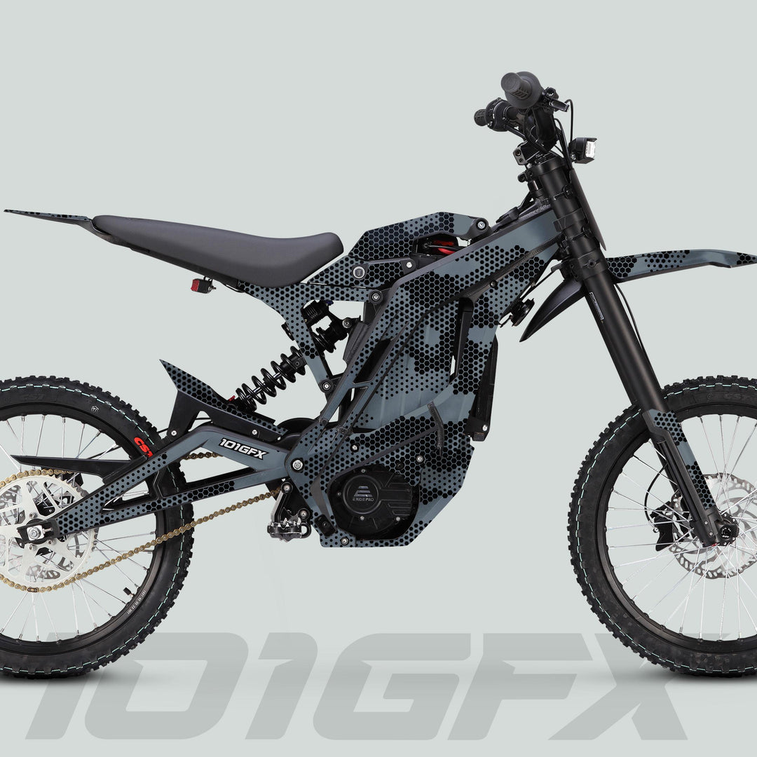 E Ride Pro SS Graphics Kit HEXOCAM GREY on a side-profile electric off-road bike with hexagonal body panel, full suspension, and knobby tires.
