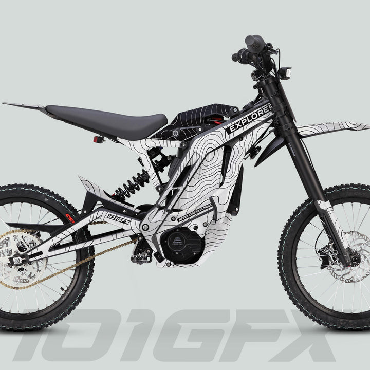 E Ride Pro SS Graphics Kit EXPLORER on electric dirt bike, featuring white-and-black topographic design, full suspension, knobby tires, and integrated battery/motor.