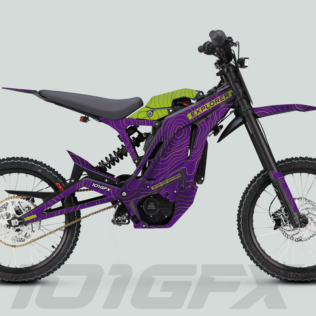 E Ride Pro SS Graphics Kit EXPLORER Purple Green on electric dirt bike, featuring bold topographic design, knobbly tires, and durable decals for protection and style.