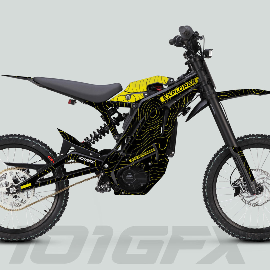 Side profile of E Ride Pro SS Graphics Kit EXPLORER Black Yellow on an off-road e-bike, featuring motocross-style frame, suspension, knobbly tires, and mid-mounted motor.
