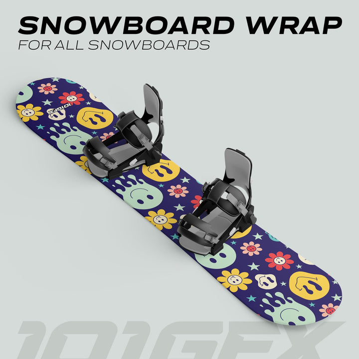 Snowboard Wrap SMILEY decals on a twin-tip snowboard with strap-in bindings, featuring playful pastel graphics on a navy background, showcasing its aesthetic and protective qualities.