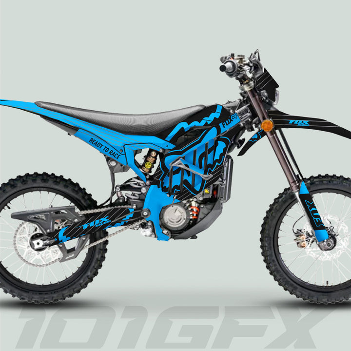 Surron Ultra Bee Graphics Kit FOX STRIPES Black Cyan on an off-road bike, featuring knobbly tires, high seat, and FOX-branded forks.