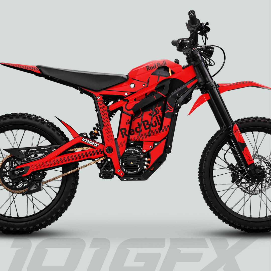 Red-and-black electric dirt bike featuring Talaria Sting MX5 PRO Graphics Kit RBULL MONO Red Bull logos, knobby tires, suspension forks, and a mid-mounted electric motor.