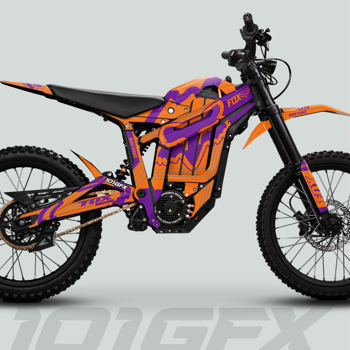 Side-profile of Talaria Sting MX5 PRO with FOX STRIPES Orange Purple Decals, featuring chunky tires, inverted forks, central battery, and spoked rims.