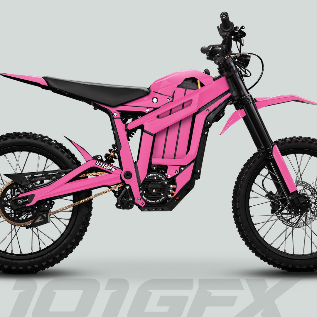 Talaria Sting MX5 PRO Graphics Kit SOLID COLOR Pink Decals on a hot-pink electric off-road motorcycle with knobby tires and minimal bodywork.