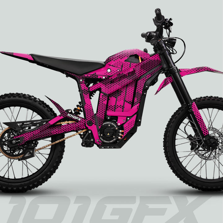 Talaria Sting MX5 PRO Graphics Kit HEXOCAM MAGENTA Decals on an off-road electric dirt bike, featuring knobby tires, chain drive, and central electric motor.
