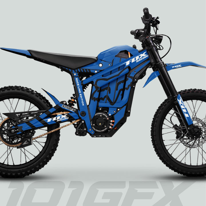 Side-view of Talaria Sting MX5 PRO with FOX RACELINE Blue Black Decals, showcasing electric motor, off-road suspension, and knobby tires with FOX Racing branding.