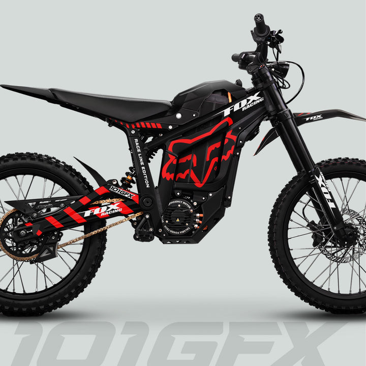 Side-view of Talaria Sting MX5 PRO Graphics Kit FOX RACELINE Black Red Decals on an electric off-road motorcycle, showcasing knobby tires and long-travel suspension.