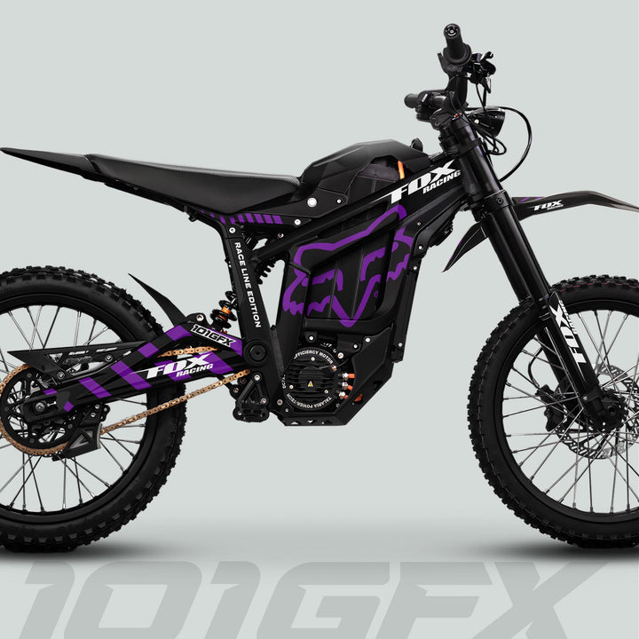 Talaria Sting MX5 PRO Graphics Kit with FOX RACELINE decals on electric dirt bike, featuring black-purple livery, knobby tires, and long-travel suspension.