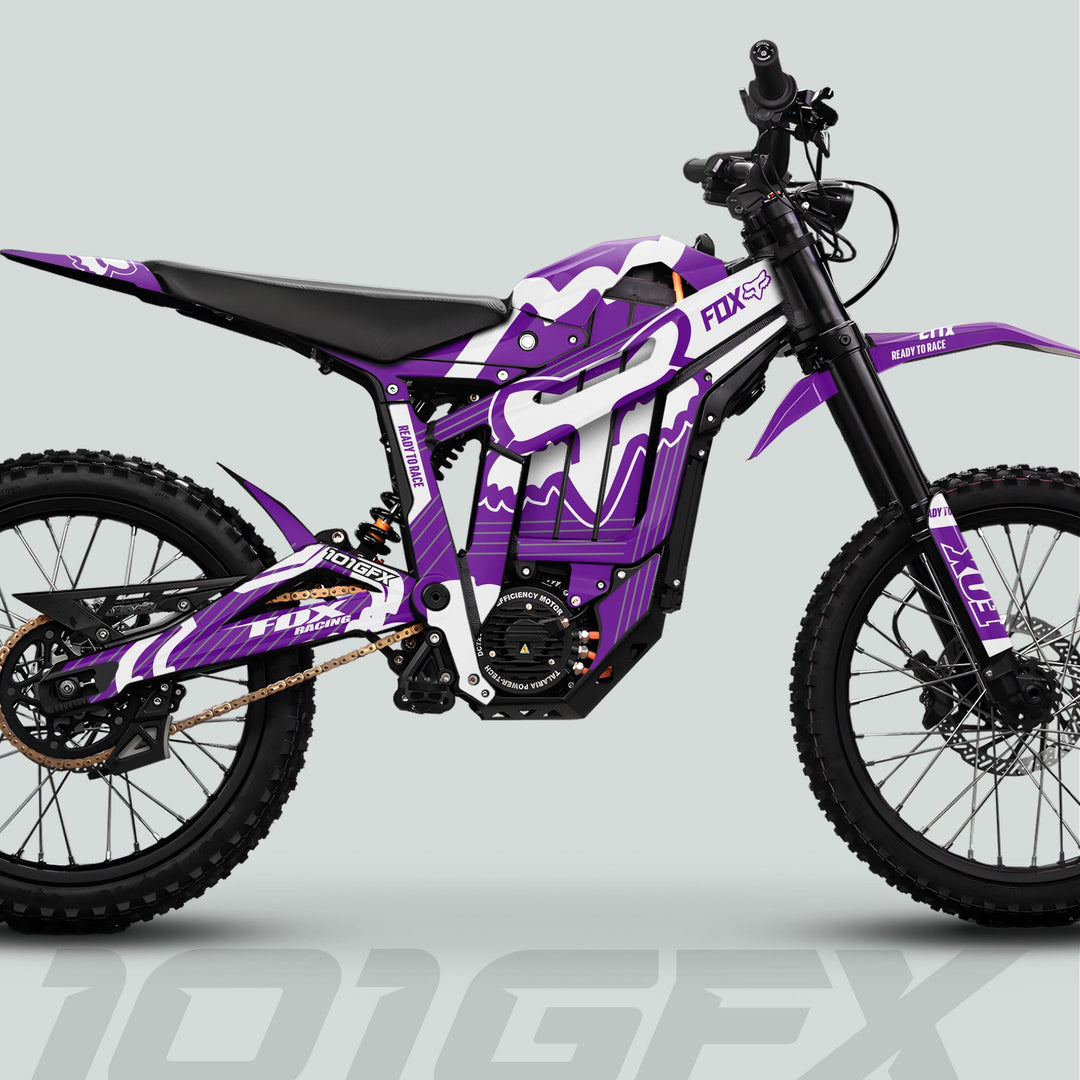 Talaria Sting MX5 PRO Graphics Kit features purple-and-white FOX STRIPES on an electric dirt bike with durable decals, enhancing off-road style and protection.