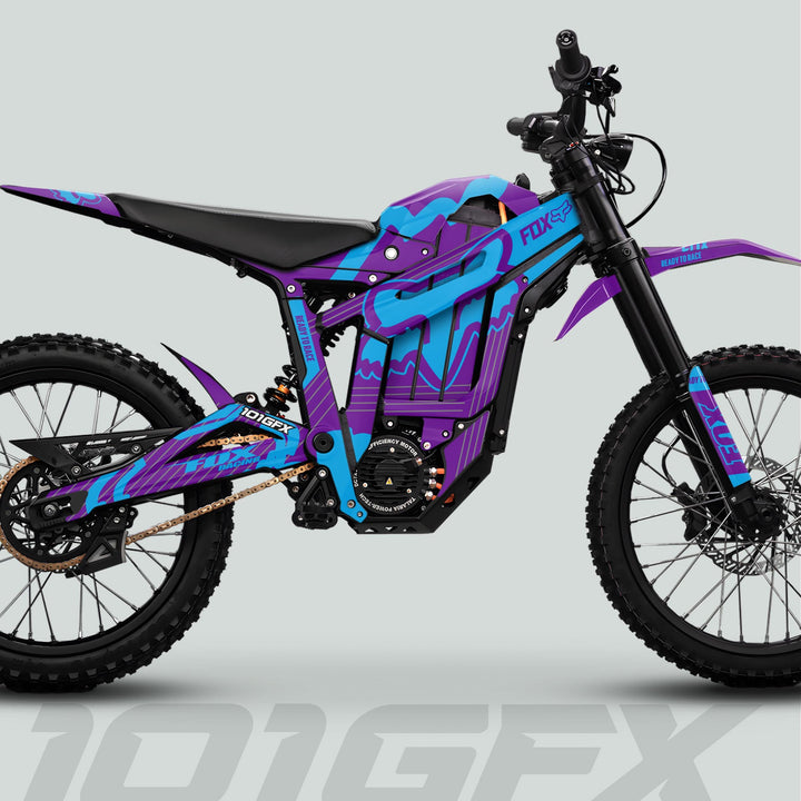 Talaria Sting MX5 PRO Graphics Kit FOX STRIPES Purple Cyan Decals on a high-performance electric dirt bike with tubular frame, long-travel suspension, and knobby tires.