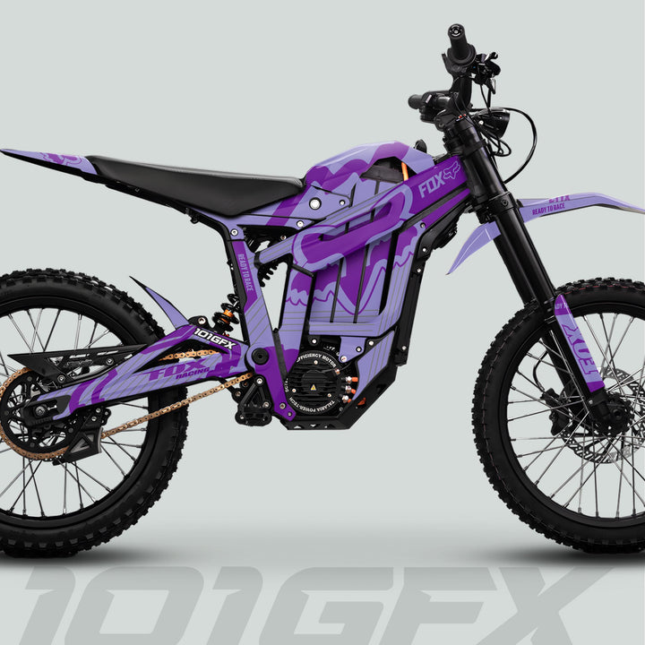 Talaria Sting MX5 PRO Graphics Kit FOX STRIPES Duo Purple Decals on an off-road electric dirt bike with FOX branding and knobby tires.