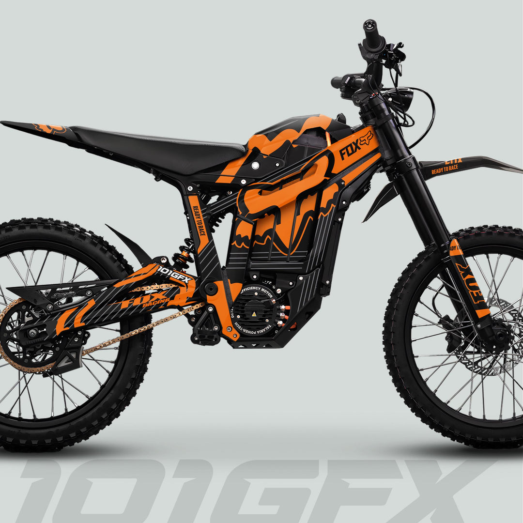 Side-profile of a Talaria Sting MX5 PRO with FOX STRIPES Black Orange Decals, featuring knobby tires, electric motor, and standout “101GFX” and “READY TO RACE” markings.