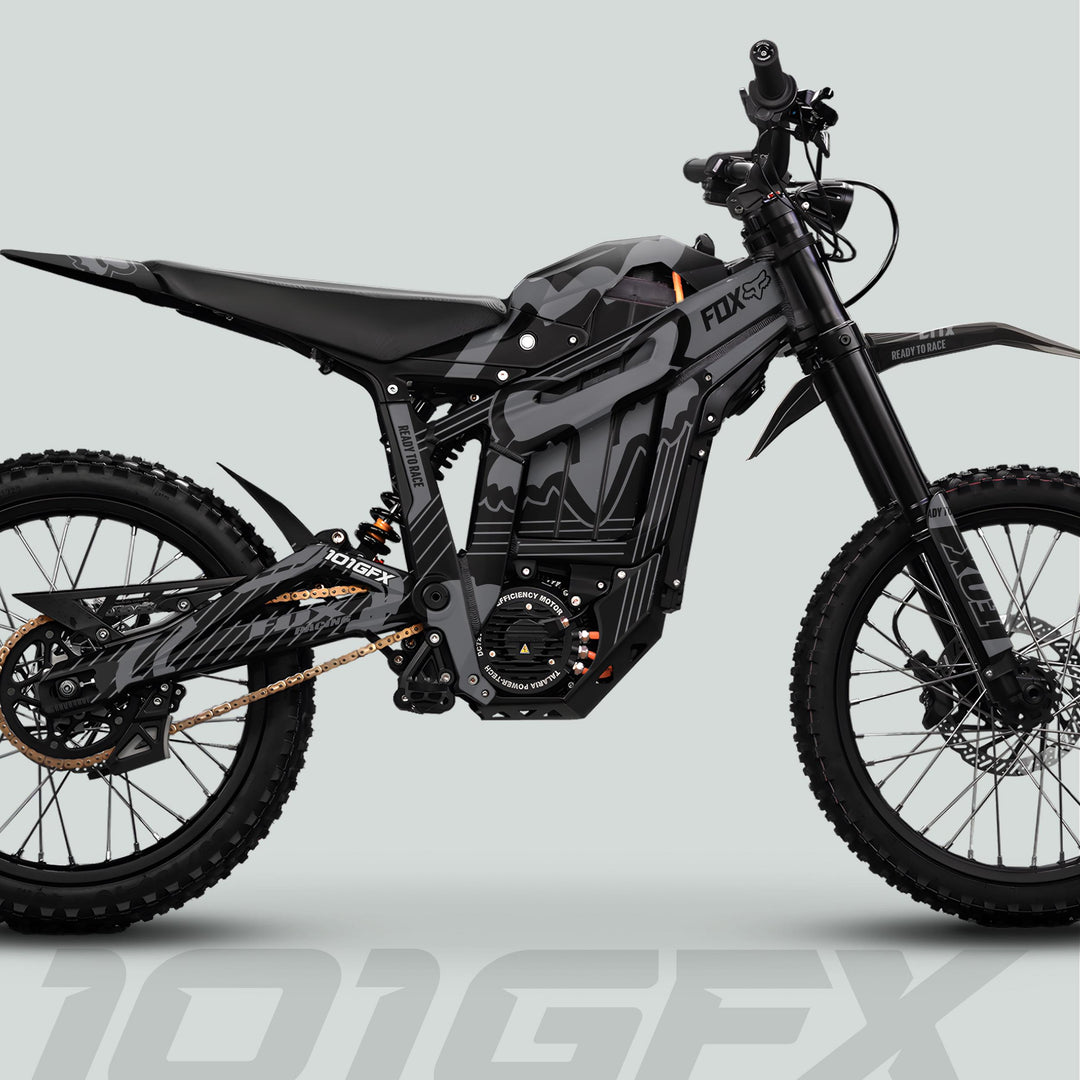 Talaria Sting MX5 PRO Graphics Kit FOX STRIPES Black Grey Decals on a high-performance off-road electric dirt bike with slim frame, suspension, and matte-black/camouflage graphics.
