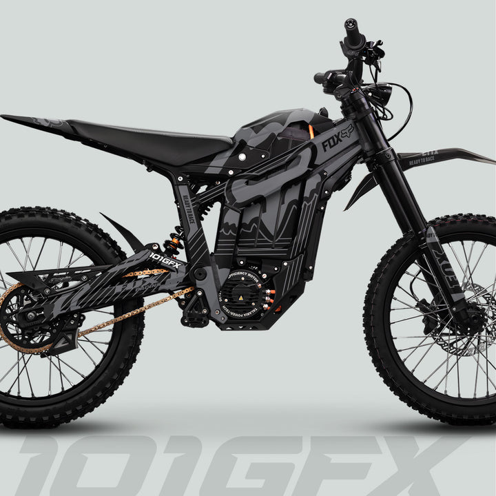 Talaria Sting MX5 PRO Graphics Kit FOX STRIPES Black Grey Decals on a high-performance off-road electric dirt bike with slim frame, suspension, and matte-black/camouflage graphics.
