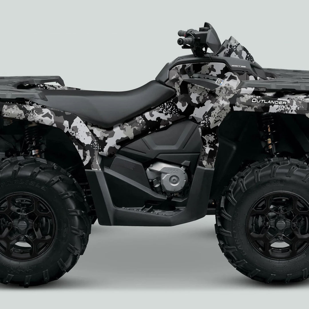 Can-Am OUTLANDER Graphics Kit SPLAT CAMO Grey on an ATV with chunky tires, black seat, and handlebars, enhancing style and protection.