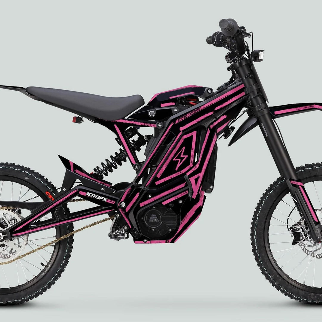 Side-profile of an off-road electric motorcycle showcasing the E Ride Pro SS Graphics Kit BRUSH Black Pink with bold pink striping on a black frame.