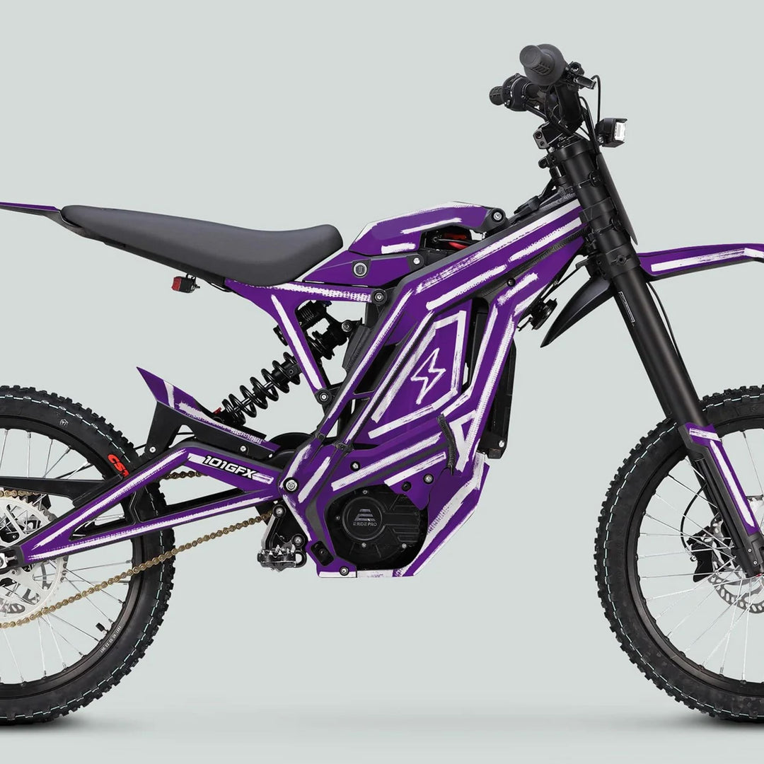 E Ride Pro SS Graphics Kit BRUSH Purple White on a purple-and-white electric dirt bike, showcasing knobby tires and sleek frame accents for enhanced style and durability.