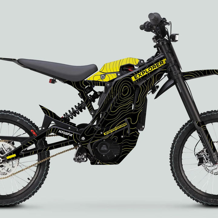 Side profile of E Ride Pro SS Graphics Kit EXPLORER Black Yellow on electric off-road bike, highlighting the durable frame, knobby tires, and distinct graphics.