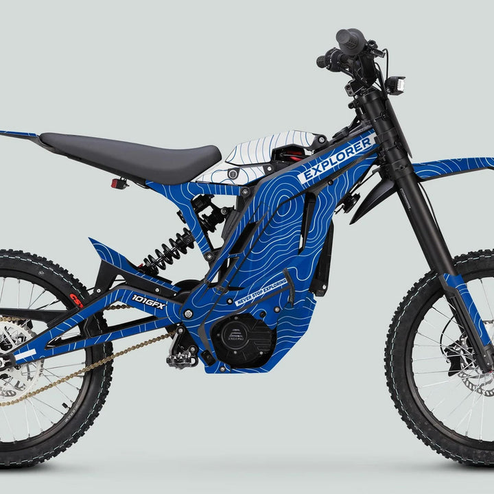 E Ride Pro SS Graphics Kit EXPLORER Blue White on a blue electric off-road bike, featuring durable vinyl decals with seamless fit and weather-resistant finish.