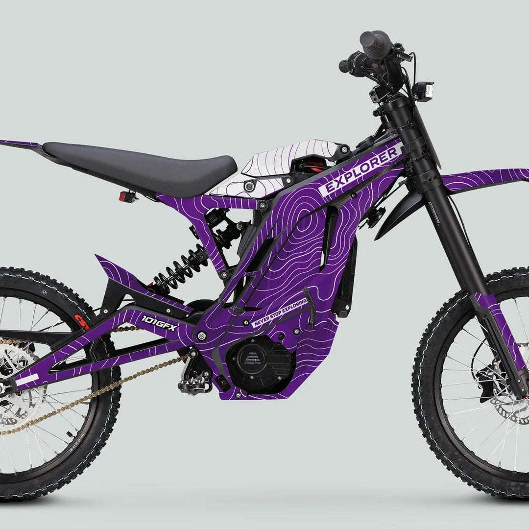 Electric off-road bike with E Ride Pro SS Graphics Kit EXPLORER Purple White, featuring purple frame, topographic-line graphics, and full suspension for rugged terrain.
