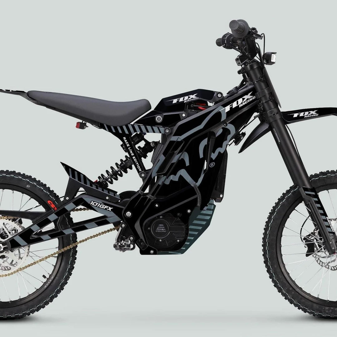E Ride Pro SS Graphics Kit FOX Race Line Black Grey on a black Fox Racing e-dirt bike featuring knobby tires, disc brakes, and minimalist seat.