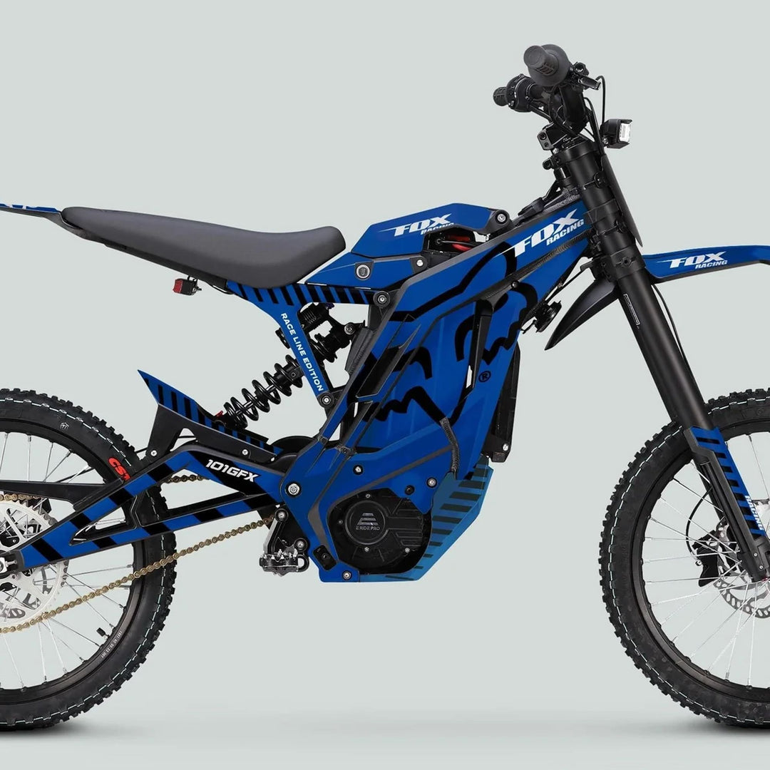 Side-view of a blue electric dirt bike featuring the E Ride Pro SS Graphics Kit FOX Race Line Blue Black with a sleek frame and durable knobby tires.