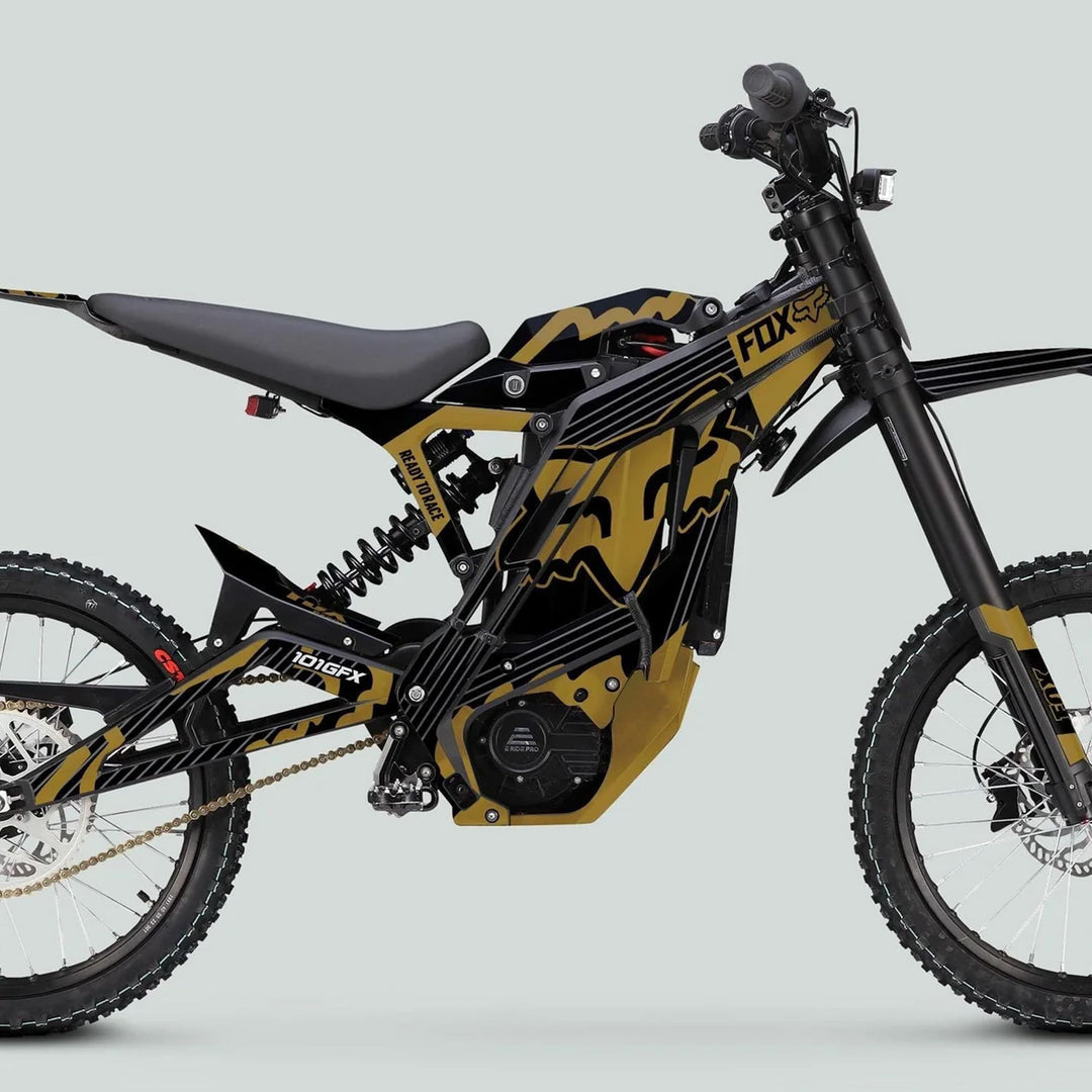 Electric off-road motorcycle with E Ride Pro SS Graphics Kit FOX R Stripes Black Gold, featuring knobby tires, FOX logo, and bold black-and-gold frame for standout style.