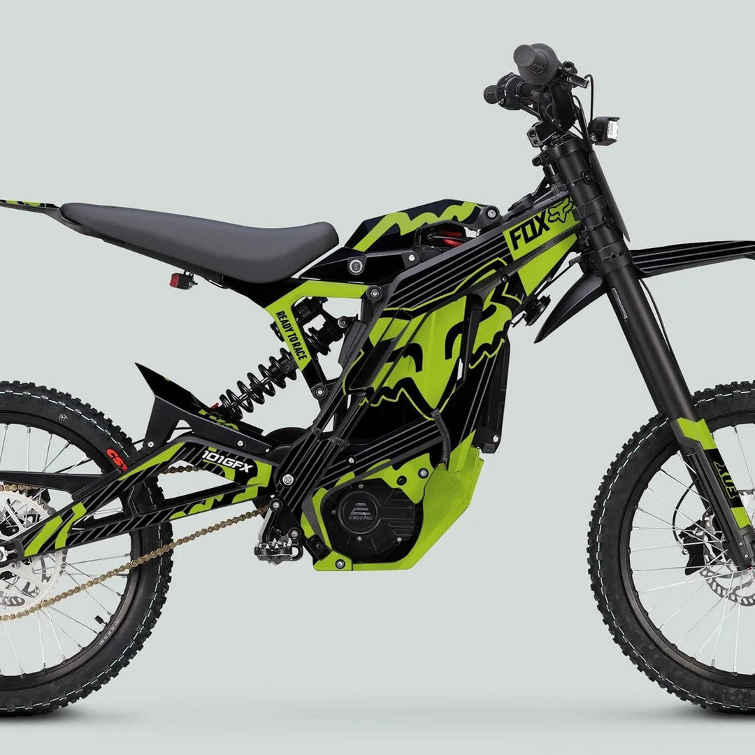 E Ride Pro SS Graphics Kit FOX R Stripes Black Green on an electric dirt bike, showcasing FOX branding, knobby tires, and striking side-view aesthetics.