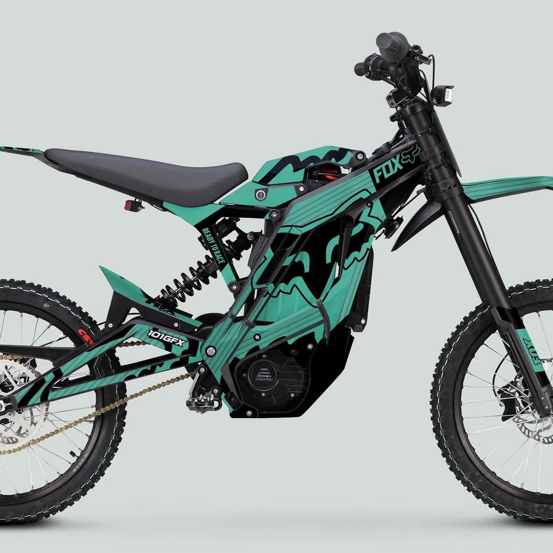 Side-profile of E Ride Pro SS Graphics Kit FOX R Stripes Mint Black on a teal and black electric dirt bike, showcasing Fox branding and rugged components.