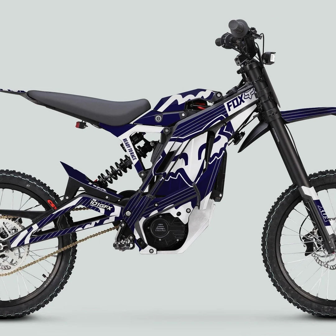Electric off-road bike with E Ride Pro SS Graphics Kit, featuring FOX R navy and white stripes, lightweight chassis, knobby tires, and disc brakes.