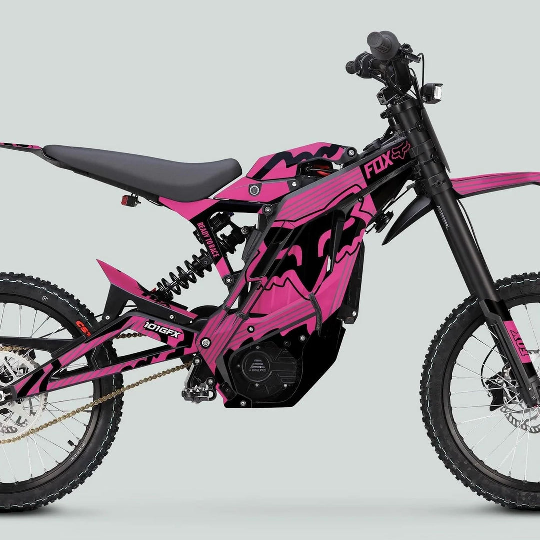 E Ride Pro SS Graphics Kit FOX R Stripes Pink Black on a pink-black electric dirt bike with knobby tires and motocross-style seat, highlighting its striking decals.