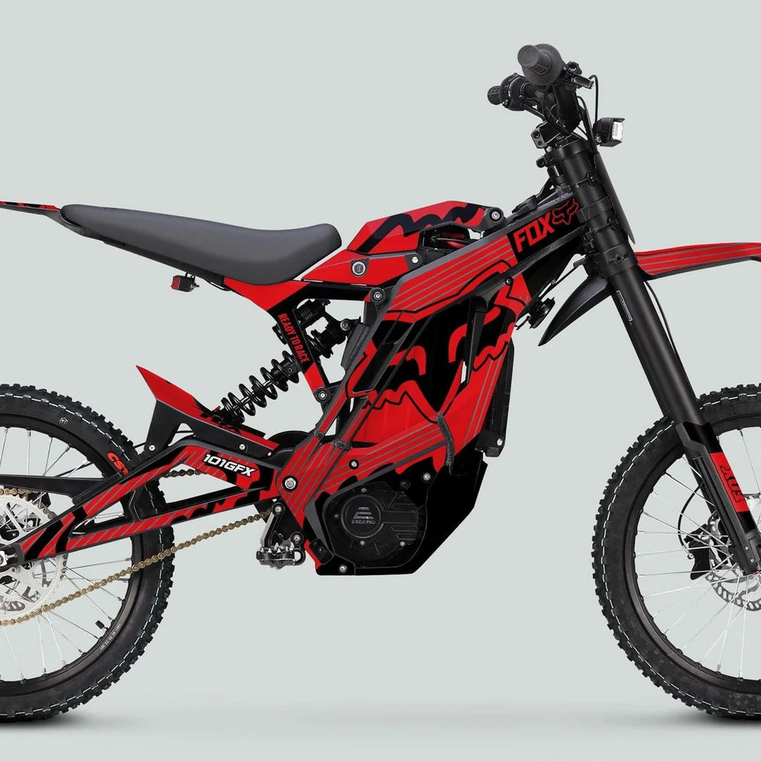 E Ride Pro SS Graphics Kit FOX R Stripes Red Black on an electric off-road motorcycle, featuring durable decals enhancing aesthetics with knobby tires, suspension, and chain drive.