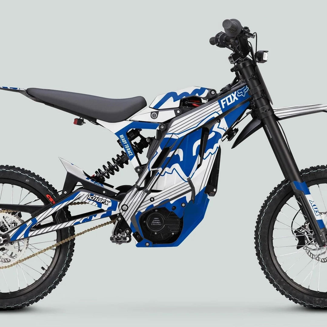E Ride Pro SS Graphics Kit FOX R Stripes White Blue on an electric dirt bike with knobby tires and Fox suspension, enhancing style and durability.