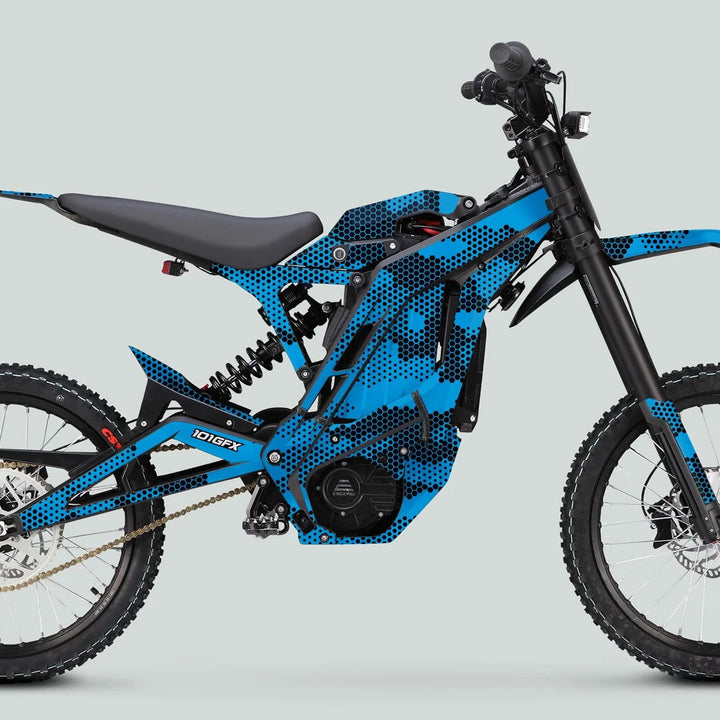 E Ride Pro SS Graphics Kit HEXOCAM CYAN on blue electric dirt-bike, showcasing black dot-pattern, coil rear shock, knobby tires, and centralized motor for enhanced style and durability.